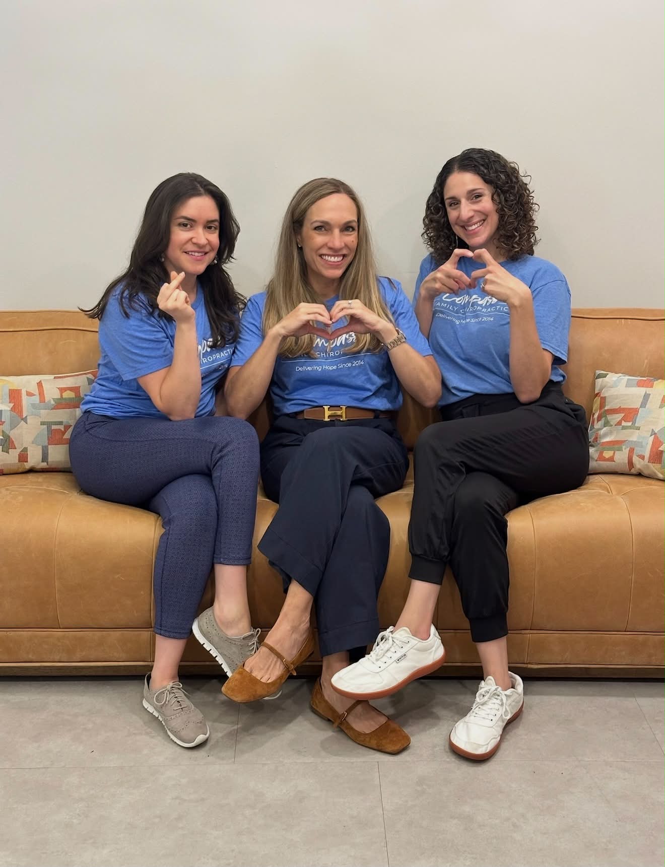 The Compass doctors making heart hands together