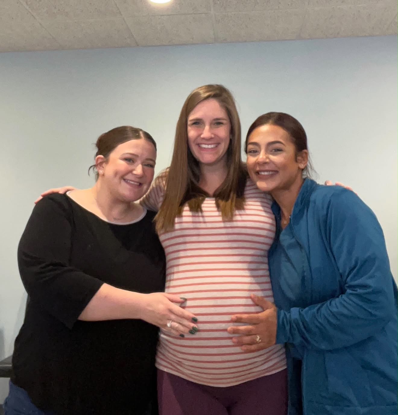 Our team hugging a pregnant patient